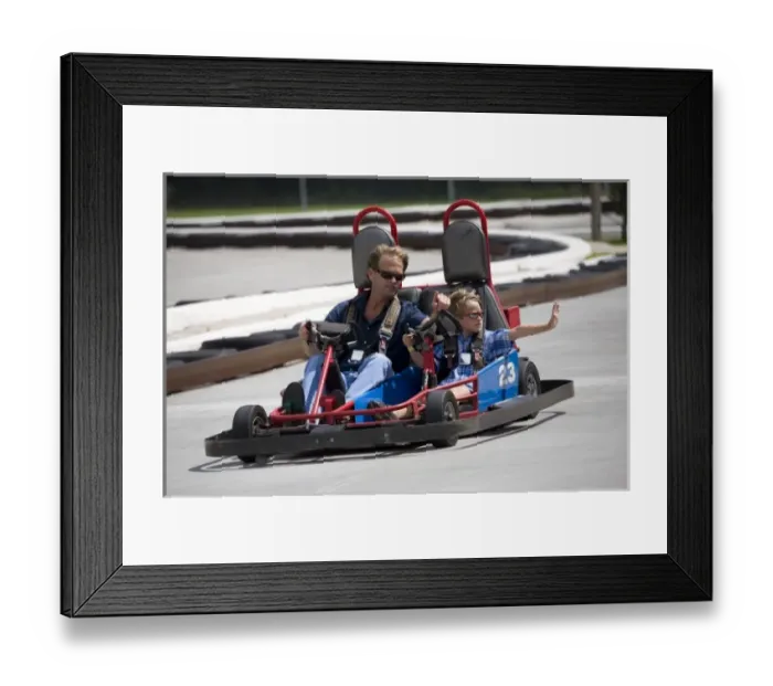 Framed Print : USA; Georgia; Savannah; Father and son riding a go kart. (MR)