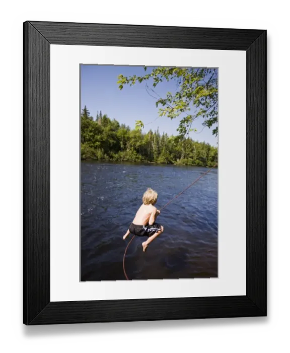 Framed Print : A boy plays on a rope swing at Mollidgewock State Park in Errol, New Hampshire. Androscoggin River Framed Print : A boy plays on a rope swing at Mollidgewock State Park in Errol, New Hampshire. Androscoggin River
