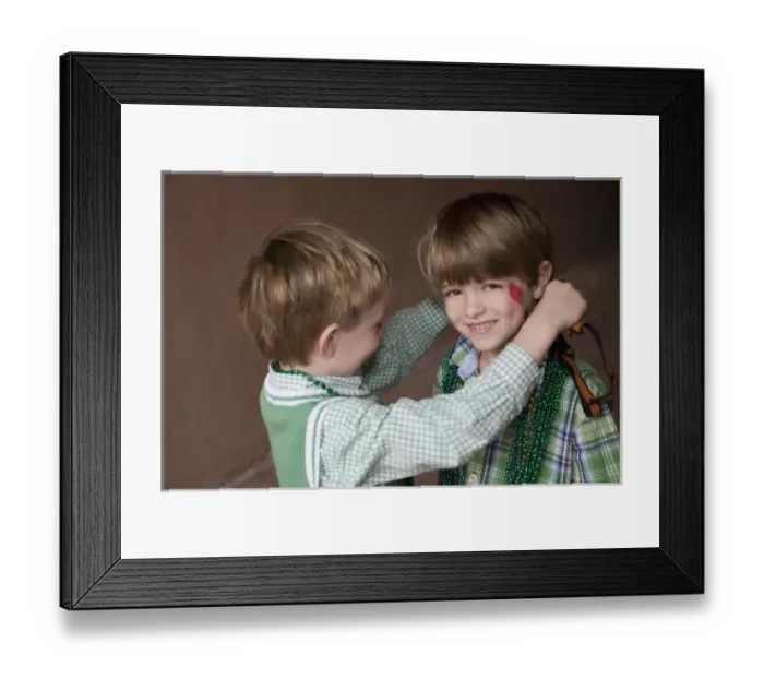 Framed Print : USA; Georgia; Savannah. Two young boys exchanging beads on St. Patricks Day. (MR) Framed Print : USA; Georgia; Savannah. Two young boys exchanging beads on St. Patricks Day. (MR)