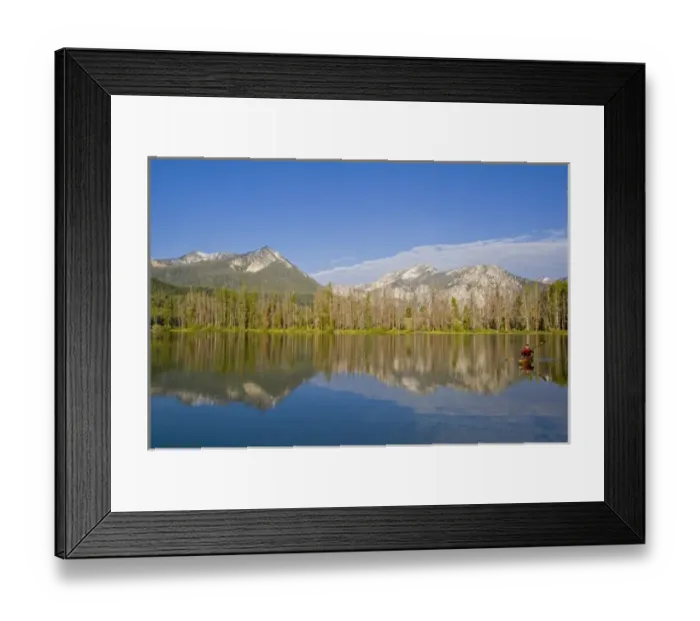 Framed Print : Paddling a sea kayak on a calm Pettit Lake in the Sawtooth Mountains of Idaho (MR)