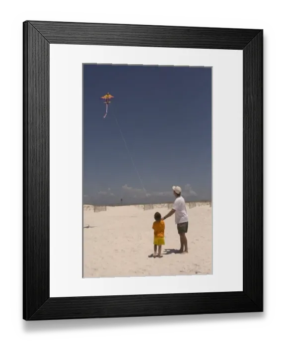 Framed Print : USA; Florida; Young boy learning to fly a kite on the beach at Pensacola. (MR) Framed Print : USA; Florida; Young boy learning to fly a kite on the beach at Pensacola. (MR)