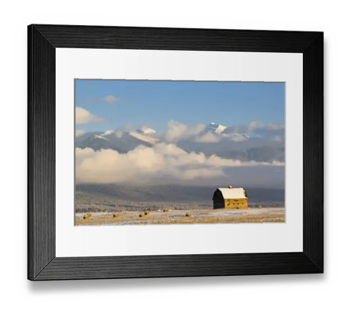 Framed Print : Rustic barn and hay bales after a fresh snow in the Mission Valley of Montana