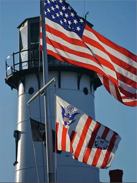 USA, Massachusetts, Chatham. An American flag and the Coast Guard flag wave in front