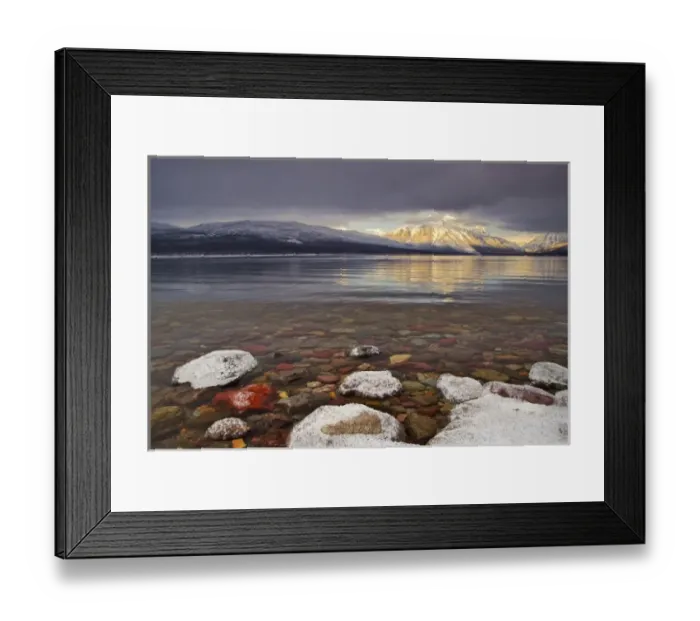 Framed Print : Sun breaks through the clouds at Lake McDonald on a winter evening in Glacier National Framed Print : Sun breaks through the clouds at Lake McDonald on a winter evening in Glacier National