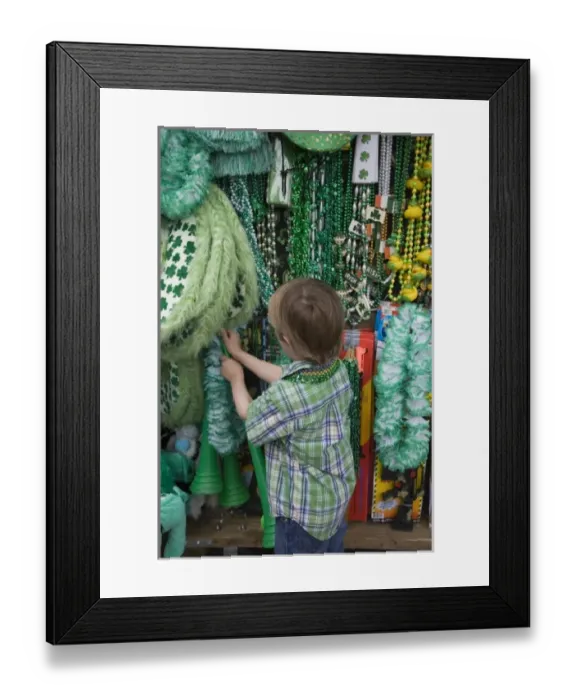 Framed Print : USA; Georgia Savannah. Young boy looking for a St. Patricks Day souvenir. (MR) Framed Print : USA; Georgia Savannah. Young boy looking for a St. Patricks Day souvenir. (MR)
