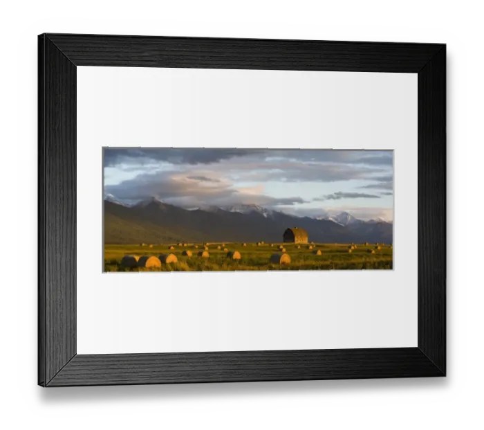 Framed Print : Old barn framed by hay bales and dramatic Mission Mountain Range in Montana