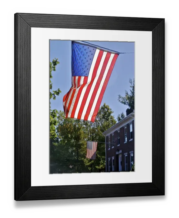 Framed Print : USA, Massachusetts, Lexington. Flags catch the sunlight over a brick home in Lexington