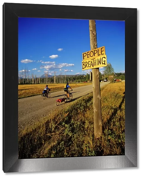 Mountain bikers head into Polebridge while riding on the Great Divide Route in Montana