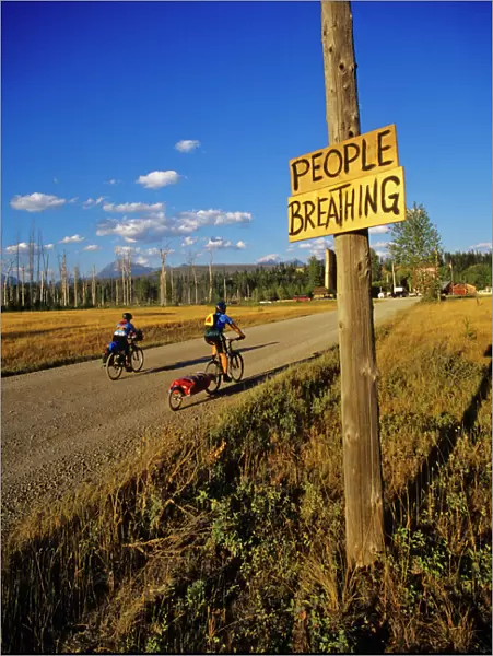 Mountain bikers head into Polebridge while riding on the Great Divide Route in Montana