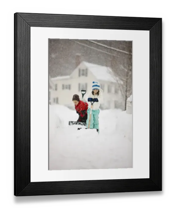 Framed Print : A brother and sister shovel snow during a snowstorm in Portsmouth, New Hampshire Framed Print : A brother and sister shovel snow during a snowstorm in Portsmouth, New Hampshire