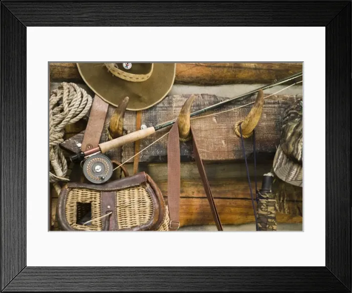 Framed Print : USA, Montana. Fishing ger and hat hang on horn pegs outside of log cabin Framed Print : USA, Montana. Fishing ger and hat hang on horn pegs outside of log cabin