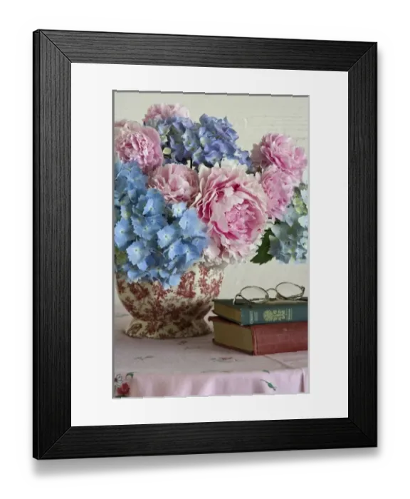 Framed Print : Close-up of hydrangea and peony flower arrangement on table next to books Framed Print : Close-up of hydrangea and peony flower arrangement on table next to books