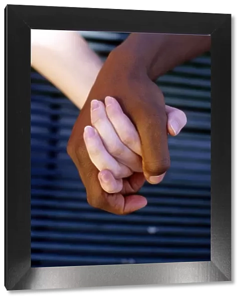 Interracial couple holding hands. MR