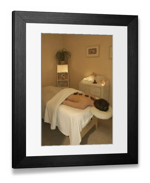 Framed Print : Released health spa woman heated stones on back