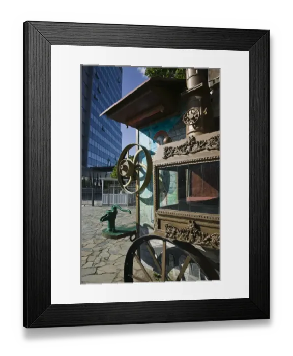 Framed Print : KOSOVO, Prishtina. Display of Old Circus Wagon and modern Kosovo Government Building Framed Print : KOSOVO, Prishtina. Display of Old Circus Wagon and modern Kosovo Government Building