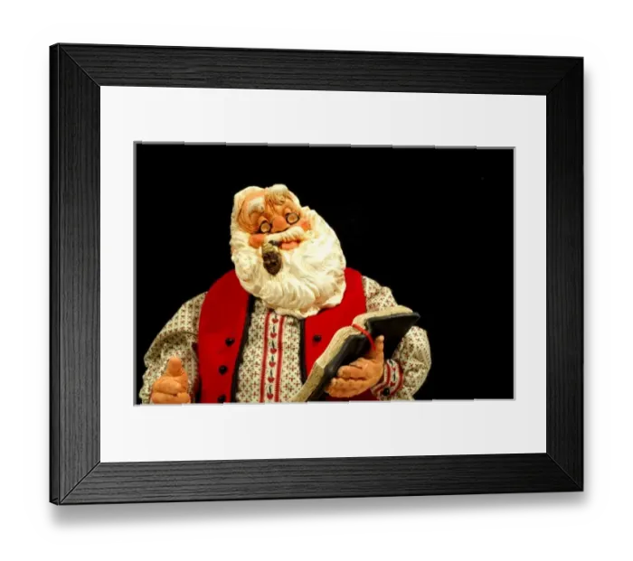 Framed Print : Still life. Simpich Caracter Doll, Santa reading book. Property released Framed Print : Still life. Simpich Caracter Doll, Santa reading book. Property released