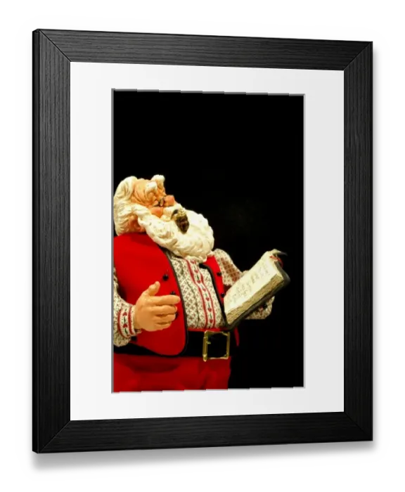 Framed Print : Still life. Simpich Caracter Doll, Santa reading book. Property released Framed Print : Still life. Simpich Caracter Doll, Santa reading book. Property released