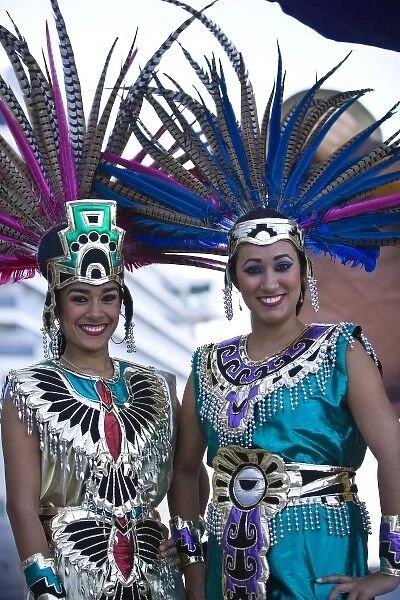 22 year old Hispanic sisters, Aztec outfits, feather head dress with Pheasant feathers