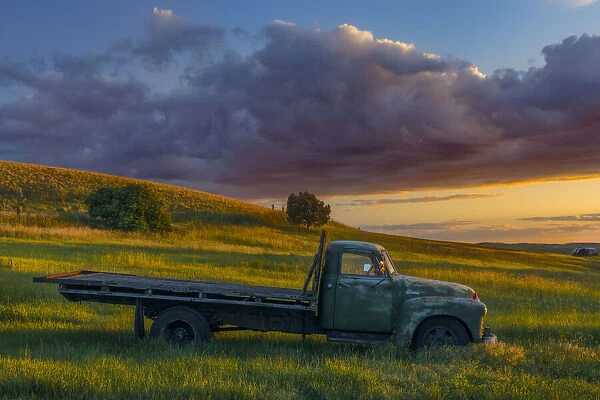 Abandoned truck on hillside at sunset, Palouse region of eastern Washington