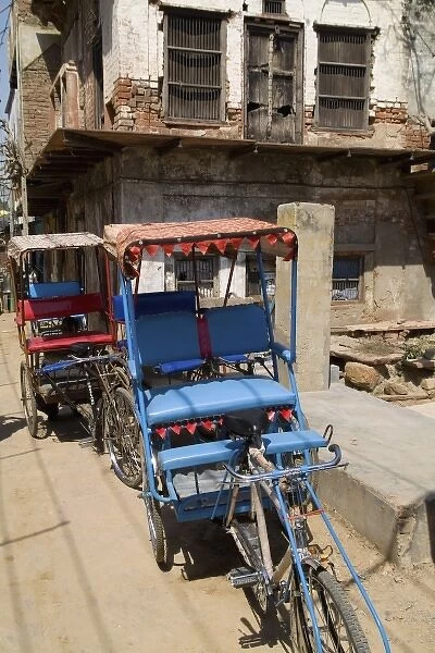 Abstract bicycle rickshaw on rugged street of the religious village of Mathura India