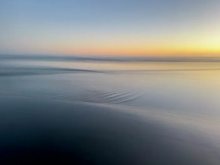 Framed Print : Abstract blur of sunset over water-covered beach