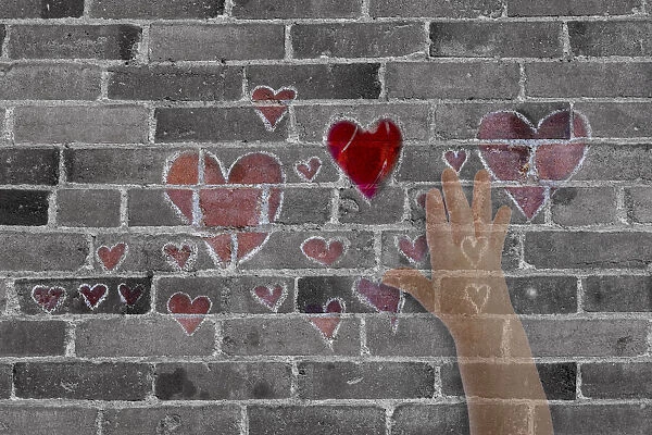 Abstract of brick wall with hearts and hand
