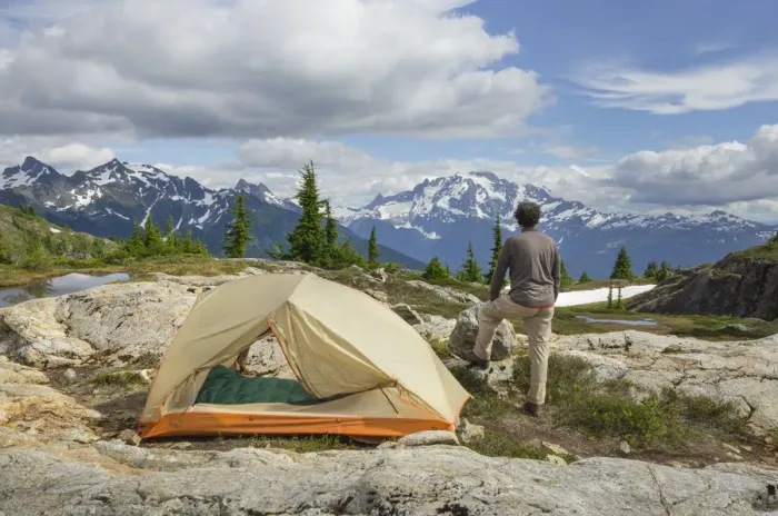 Framed Print : Adult man admiring view from backcountry campsite Framed Print : Adult man admiring view from backcountry campsite