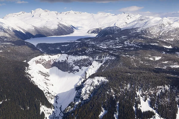 Aerial view of frozen Garibaldi Lake and lava barrier in the foreground