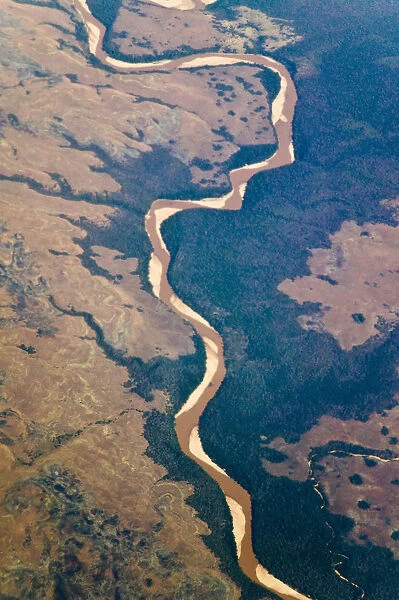 Aerial view of river flowing through land below, Madagascar