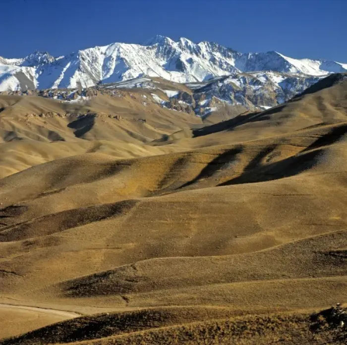 Framed Print : Afghanistan, Bamian Valley. Rolling hills lead to the snow fields of the rugged Hindu