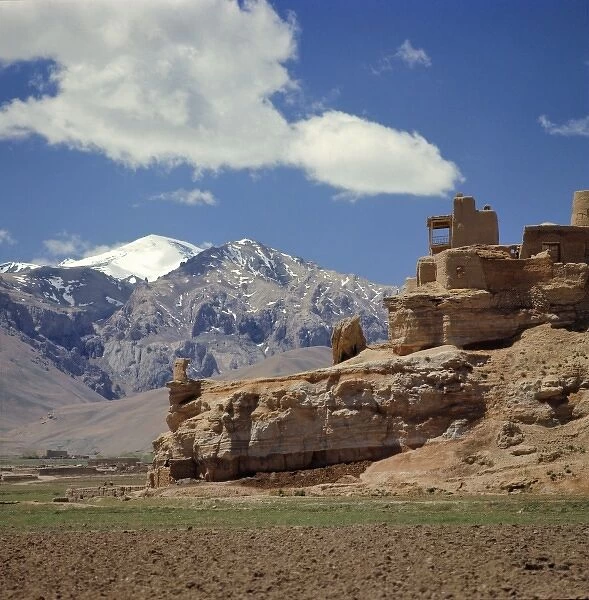 Afghanistan, Bamian Valley. The ruins of a lookout languish above pastures in the Bamian Valley