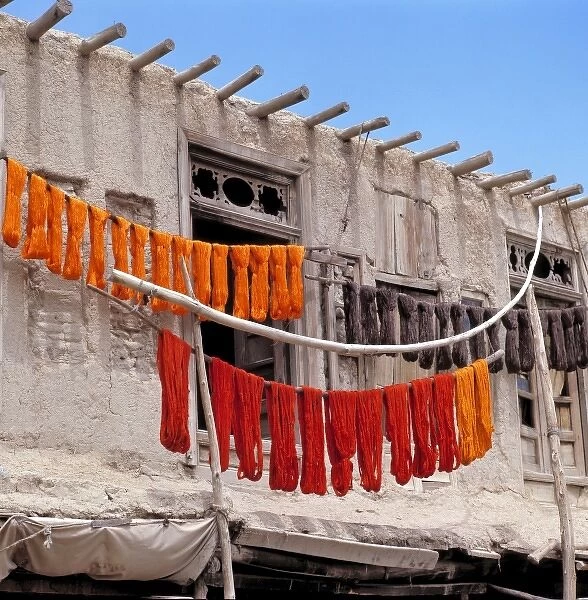 Afghanistan, Ghazni. Brightly-colored dyed wool dries on poles in Ghazni in Afghanistan