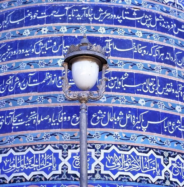 Afghanistan, Herat. An ornate street lamp stands out against the blue-tiled wall