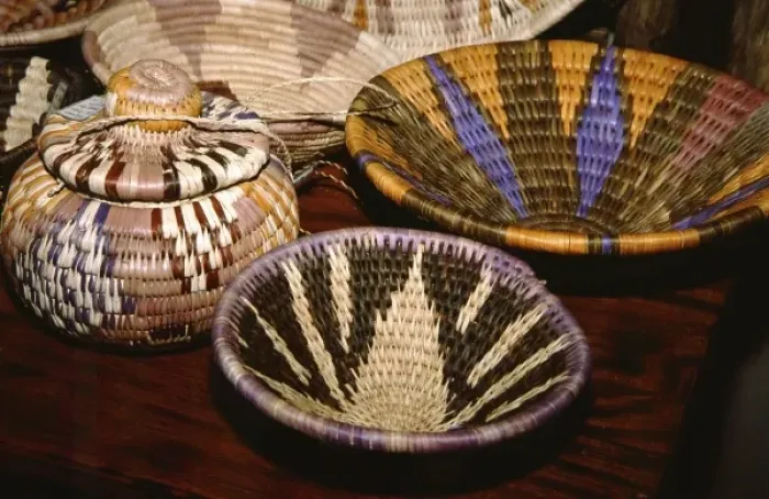 Framed Print : Africa, Botswana, Okavango Delta, Jao Reserve, Tubu Tree. Colorful camp staff made reed baskets