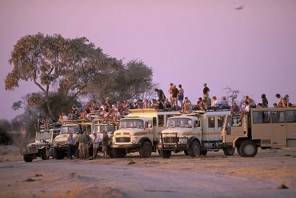 Africa, Botswana, Savuti. Overland vehicles at waterhole