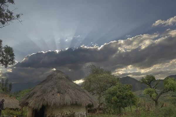 Africa, Ethiopia, Regia region, Bargoba village. Streaks of sunlight stream from behind clouds