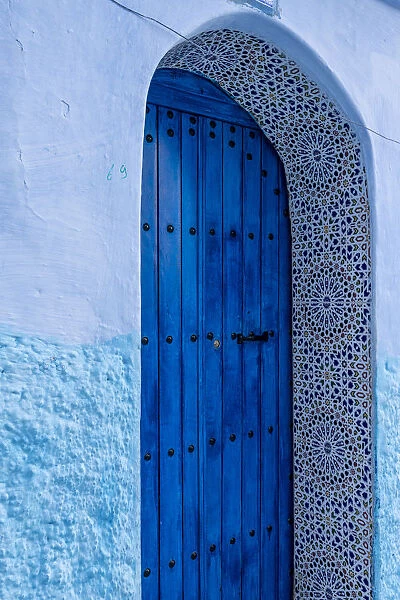 Africa, Morocco, Chefchaouen. Arch over wooden door
