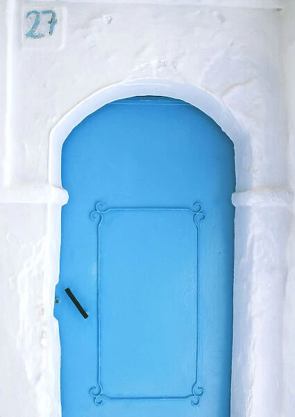 Africa, Morocco, Chefchaouen. Blue door in white building