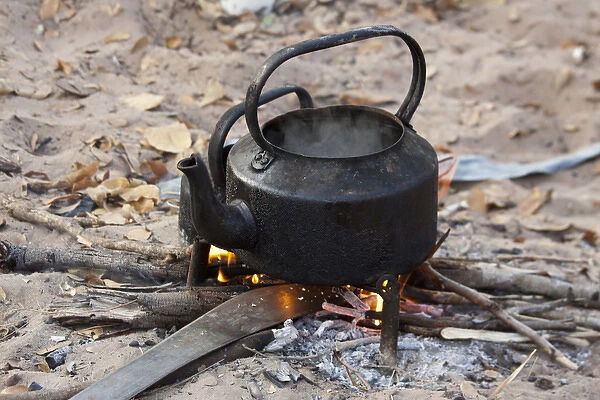 Africa, Namibia, Bushmanland, Nhoma. Kettle heats on an open fire in the Bushman village