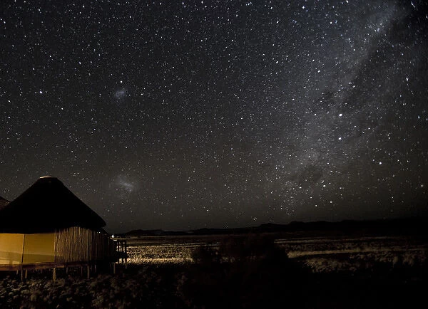 Africa, Namibia, Namib-Naukluft Park, Dune Lodge. Lodging hut, Magellanic Clouds, and Milky Way