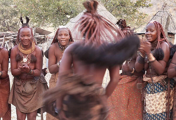Africa, Namibia, Opuwo. Himba woman in motion during a dance