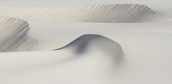 Africa, South Africa. Scuplted shapes of white sand dunes