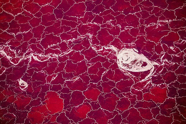 Africa, Tanzania, Aerial view of patterns of red algae and salt formations in shallow