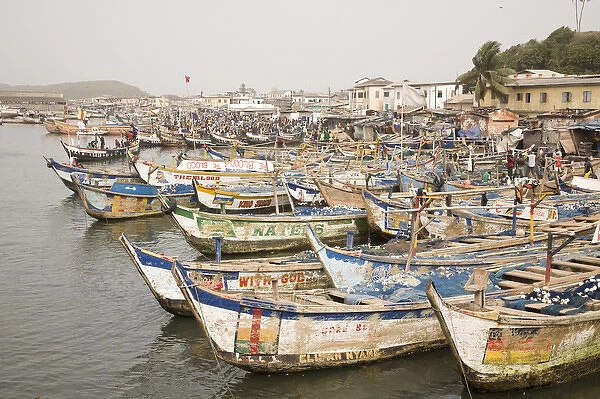 Africa, West Africa, Ghana, Elmina. Colorful hand-painted fishing boats tied up at