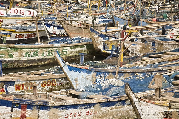 Africa, West Africa, Ghana, Elmina. Colorful hand-painted fishing boats tied up at