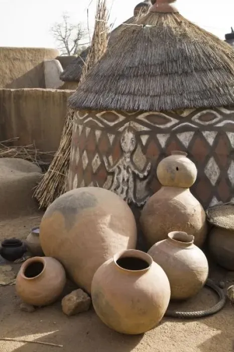 Framed Print : Africa, West Africa, Ghana, Sirigu. Handcrafted pottery leaning against traditional