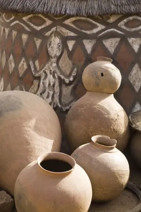 Framed Print : Africa, West Africa, Ghana, Sirigu. Handcrafted pottery leaning against traditional