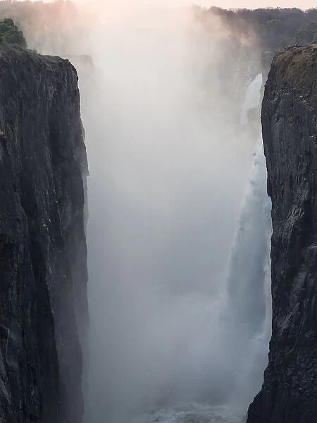 Africa, Zimbabwe, Victoria Falls. Waterfall and spray at sunrise