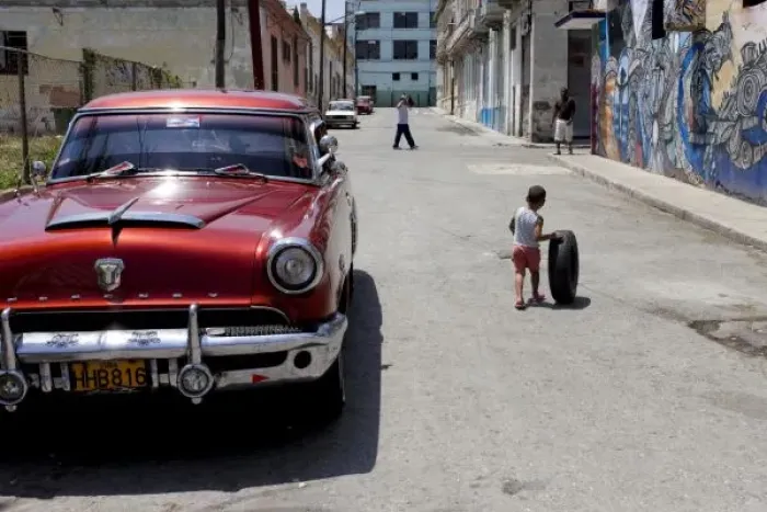 Framed Print : African Hamel district, Havana, Cuba, UNESCO World Heritage City. Child playing with old tire