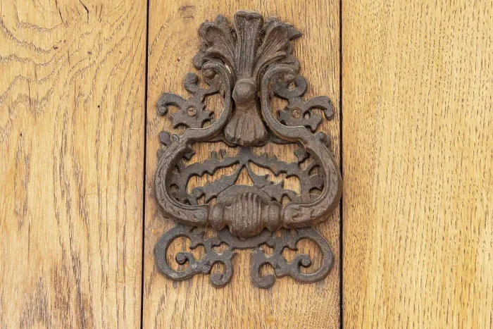 Framed Print : Aigues-Mortes, Gard, Occitania, France. An old rusted knocker on a wooden door